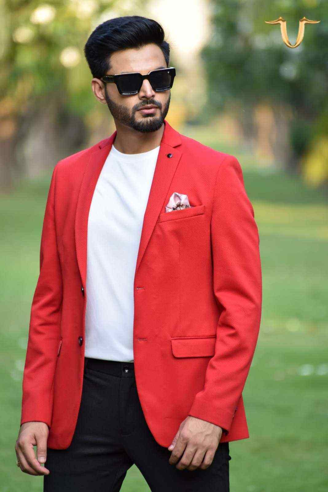 A versatile red blazer that can be dressed up or down. The blazer is made from a soft, stretchy fabric and features a trendy all-over print