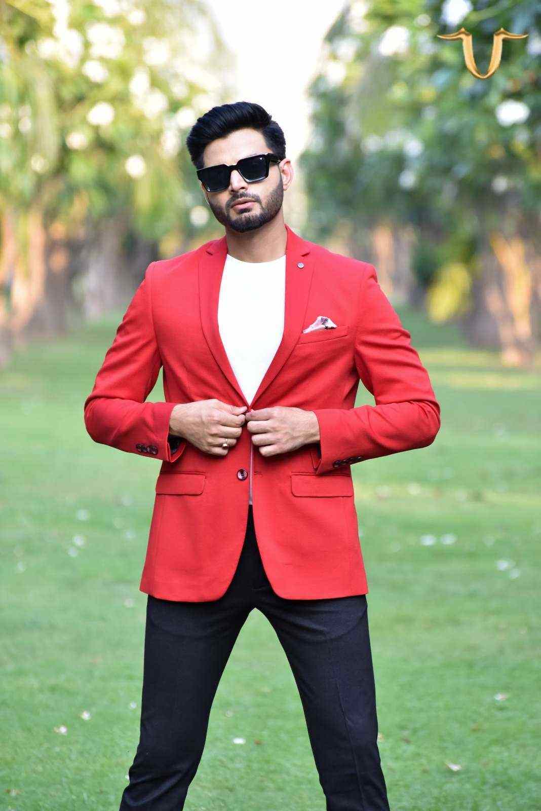 A boldly patterned red blazer made from a comfortable, machine-knitted fabric. The blazer has a contemporary design and features a unique, eye-catching print.