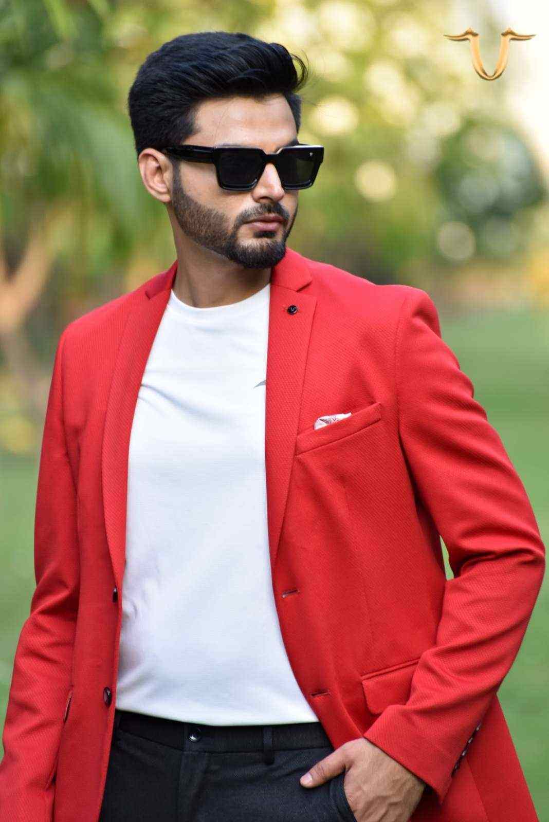 A fashion-forward red blazer that is perfect for making a statement. The blazer is made from a high-quality, printed fabric and has a flattering, contemporary fit.